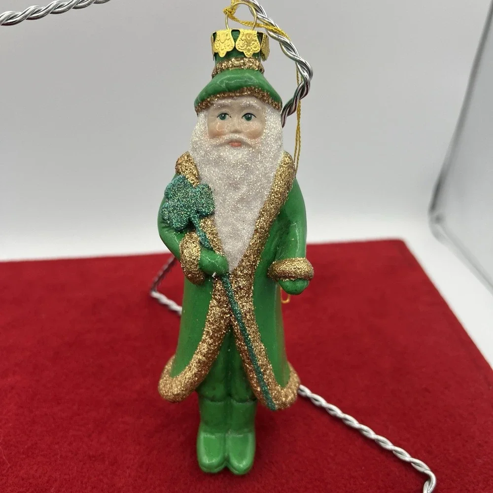 vintage glass Christmas ornament depicting Santa Claus dressed‎ in green